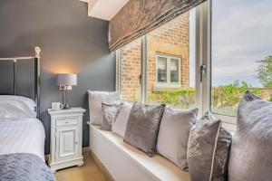 a bedroom with a bed and a window with pillows at 1 Bed in Crakehall oc-o30357 in Crakehall