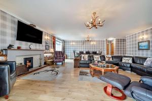 a living room with a couch and a fireplace at 4 Bed in Lochgoilhead oc-j30107 in Carrick