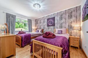 a bedroom with two beds and a window at 4 Bed in Lochgoilhead oc-j30107 in Carrick