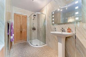 a bathroom with a glass shower and a sink at 4 Bed in Lochgoilhead oc-j30107 in Carrick +21 photos