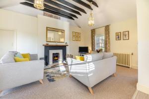 a living room with two couches and a fireplace at 2 Bed in Cornhill-on-Tweed oc-d30765 in Cornhill-on-tweed