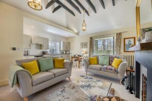 a living room with two couches and a kitchen at 2 Bed in Cornhill-on-Tweed oc-d30765 in Cornhill-on-tweed