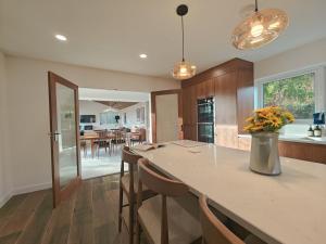 a kitchen with a large island with chairs and a table at 5 Bed in Tealby oc-t30618 in Tealby