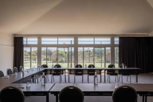a conference room with tables and chairs and a large window at Mantra on Salt Beach in Kingscliff +121 photos