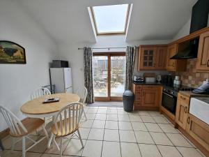 a kitchen with a table and a table and chairs at 3 Bed in Aviemore oc-s30815 in Aviemore