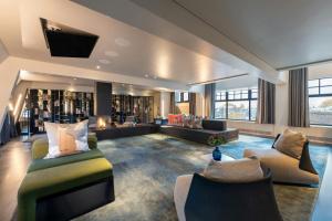 a large living room with couches and a tv at W Amsterdam in Amsterdam