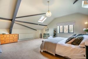 a bedroom with a large bed and a window at 4 Bed in Ewhurst Green oc-w31032 in Hurst Green