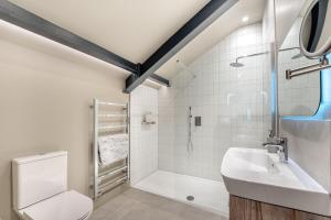 a bathroom with a shower and a toilet and a sink at 4 Bed in Ewhurst Green oc-w31032 in Hurst Green +30 photos