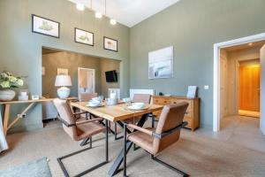a dining room with a wooden table and chairs at 4 Bed in Ewhurst Green oc-w31032 in Hurst Green