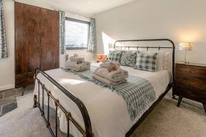 a bedroom with a bed with two pillows on it at 5 Bed in Stibb oc-f31065 in Poughill