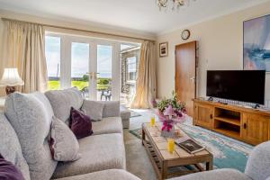 a living room with a couch and a tv at 3 Bed in Southerndown oc-l10852 in Southerndown