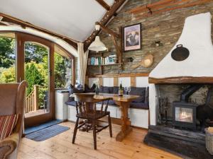 a living room with a fireplace and a table at 2 Bed in Hebron oc-y30098 in Whitland