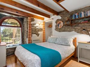 a bedroom with a bed and a stone wall at 2 Bed in Hebron oc-y30098 in Whitland