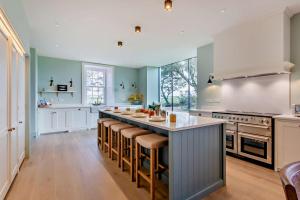 a large kitchen with a large island with bar stools at 3 Bed in Scarfskerry oc-o30016 in Scarfskerry