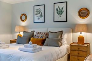 a bedroom with a white bed with towels on it at 3 Bed in Scarfskerry oc-o30016 in Scarfskerry