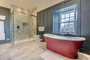 a bathroom with a large tub and a shower at 3 Bed in Scarfskerry oc-o30016 in Scarfskerry +27 photos