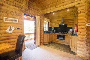 a kitchen in a log cabin with a window at 2 Bed in Felton oc-c30643 in Felton +13 photos