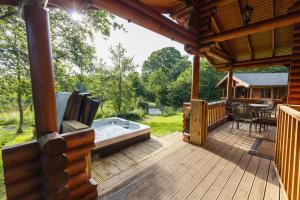 a large wooden deck with a hot tub on it at 2 Bed in Felton oc-c30643 in Felton
