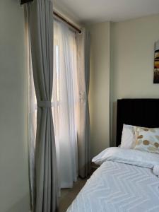 a bedroom with a bed and a window at Alyahomes in Nairobi