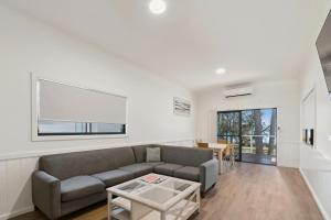 a living room with a couch and a table at Ingenia Holidays Lake Conjola in Conjola
