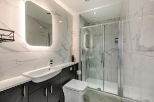 a bathroom with a shower and a toilet and a sink at 4 Bed in Holmfirth oc-s31134 in Holmfirth +26 photos