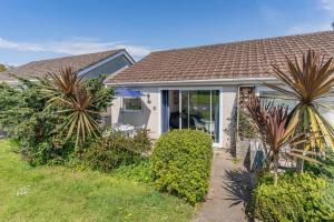 a house with palm trees in front of it at 2 Bed in Oxwich oc-l31089 in Oxwich