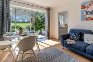 a living room with a blue couch and a table at 2 Bed in Oxwich oc-l31089 in Oxwich