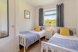 two beds in a small room with a window at 2 Bed in Oxwich oc-l31089 in Oxwich