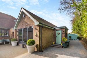a brick house with a green door at 1 Bed in Hunmanby oc-w30527 in Hunmanby