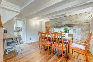 a dining room with a stone wall and a table and chairs at 3 Bed in Egloshayle oc-m32201 in Egloshayle