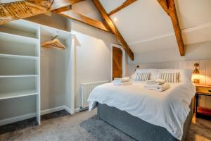 a bedroom with a large bed with white sheets at 3 Bed in Egloshayle oc-m32201 in Egloshayle