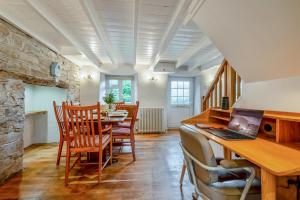 a dining room with a table with chairs and a laptop at 3 Bed in Egloshayle oc-m32201 in Egloshayle