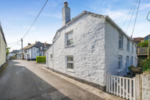 a white stone house on the side of a street at 3 Bed in Egloshayle oc-m32201 in Egloshayle +25 photos