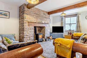 a living room with a stone fireplace and furniture at 2 Bed in Pentre Bach oc-b30875 in Pentre-bâch