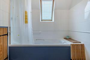 a white bathroom with a tub and a shower at 2 Bed in Pentre Bach oc-b30875 in Pentre-bâch +22 photos