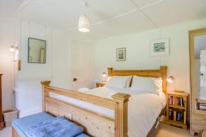 a bedroom with a large bed with a wooden frame at 2 Bed in Stalham oc-u32571 in Stalham