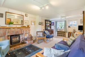 a living room with a couch and a fireplace at 2 Bed in Stalham oc-u32571 in Stalham