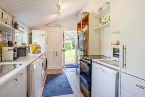 a kitchen with white cabinets and a blue rug at 2 Bed in Stalham oc-u32571 in Stalham +18 photos