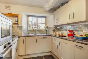 a kitchen with white cabinets and a sink at 3 Bed in Windermere oc-b31667 in Crook
