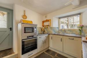 a kitchen with white cabinets and a sink and a microwave at 3 Bed in Windermere oc-b31667 in Crook +13 photos