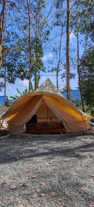a tent is set up on the ground at Gaharu glamping park in Jerantut