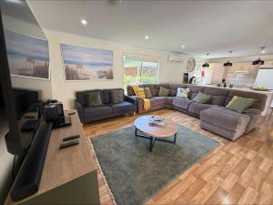 a living room with a couch and a table at Sea Change Coobowie in Coobowie