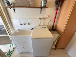 a small bathroom with a sink and a toilet at Sea Change Coobowie in Coobowie +19 photos