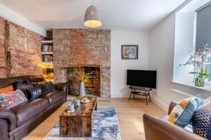 a living room with a couch and a fireplace at 3 Bed in Crickhowell oc-r32122 in Crickhowell