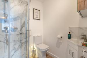 a white bathroom with a toilet and a shower at 3 Bed in Crickhowell oc-r32122 in Crickhowell +26 photos