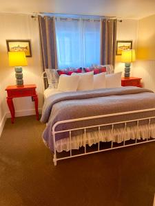 a bedroom with a large bed with two lamps at Oceanhouse in Homer +54 photos