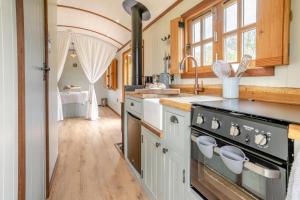 a kitchen with a stove and a sink at 1 Bed in Brecon oc-t31948 in Bronllys