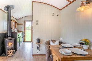 a kitchen and dining room with a table and a fireplace at 1 Bed in Brecon oc-t31948 in Bronllys +15 photos