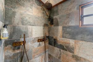 a shower in a bathroom with a stone wall at 1 Bed in Brecon oc-t31948 in Bronllys