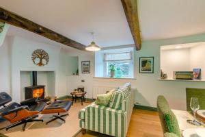 a living room with a couch and chairs and a fireplace at 3 Bed in Caldbeck oc-h30704 in Caldbeck